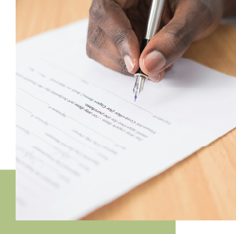 photo of a hand signing a contract